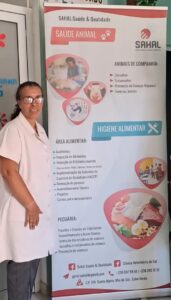 Female veterinarian in a white coat standing beside a SAHAL banner about animal health and food hygiene.